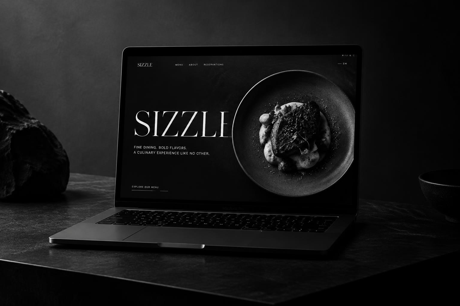 Fine dining restaurant website on a laptop, dark monochrome